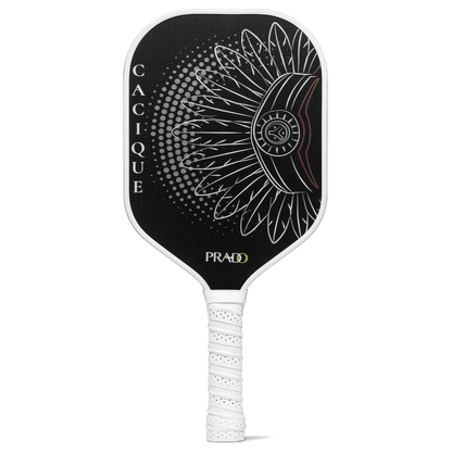 Front view of the Prado Activewear Cacique Pickleball Paddle, featuring a black Raw Carbon T700 face and a white Taíno-inspired graphic.