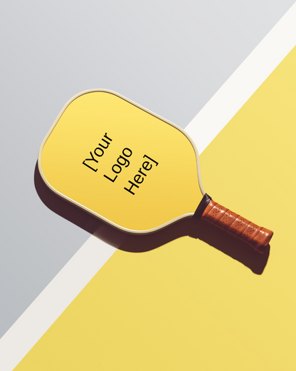 Customizable thermoformed carbon fiber pickleball paddle with T700 face and ergonomic grip, yellow surface for logo placement